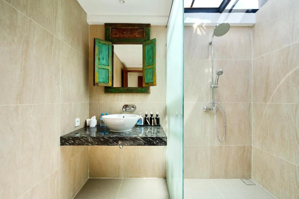 Bathroom 3 at Villa Carissa with rain shower and marble countertop