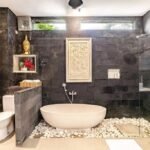 Bathroom 1: A cultural oasis with Balinese hand-carved window and mirror at Villa Carissa.